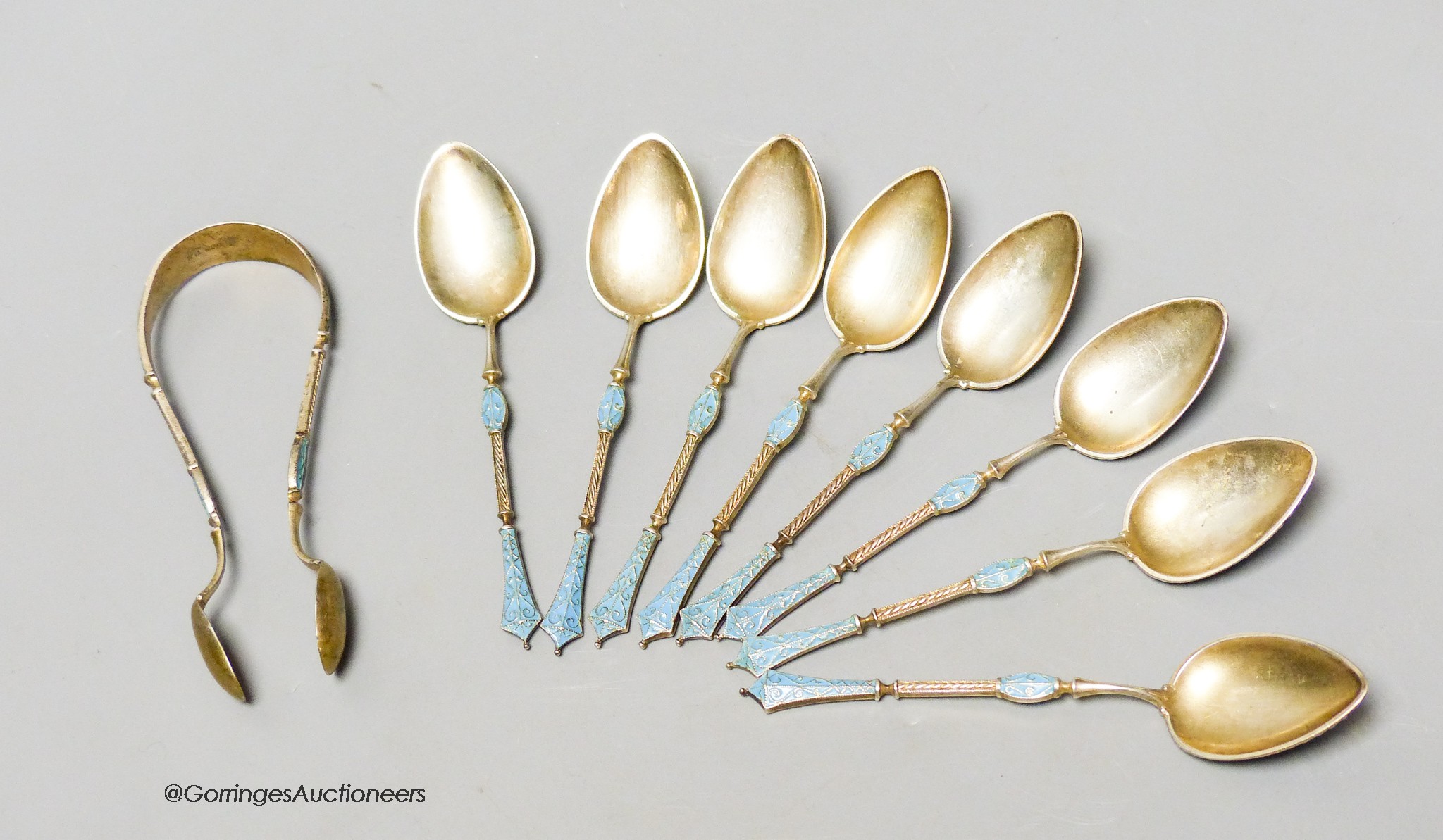 A set of eight Norwegian white metal and enamel coffee spoons and sugar tongs, by Marius Hammer, tongs only marked, gross 3 oz.